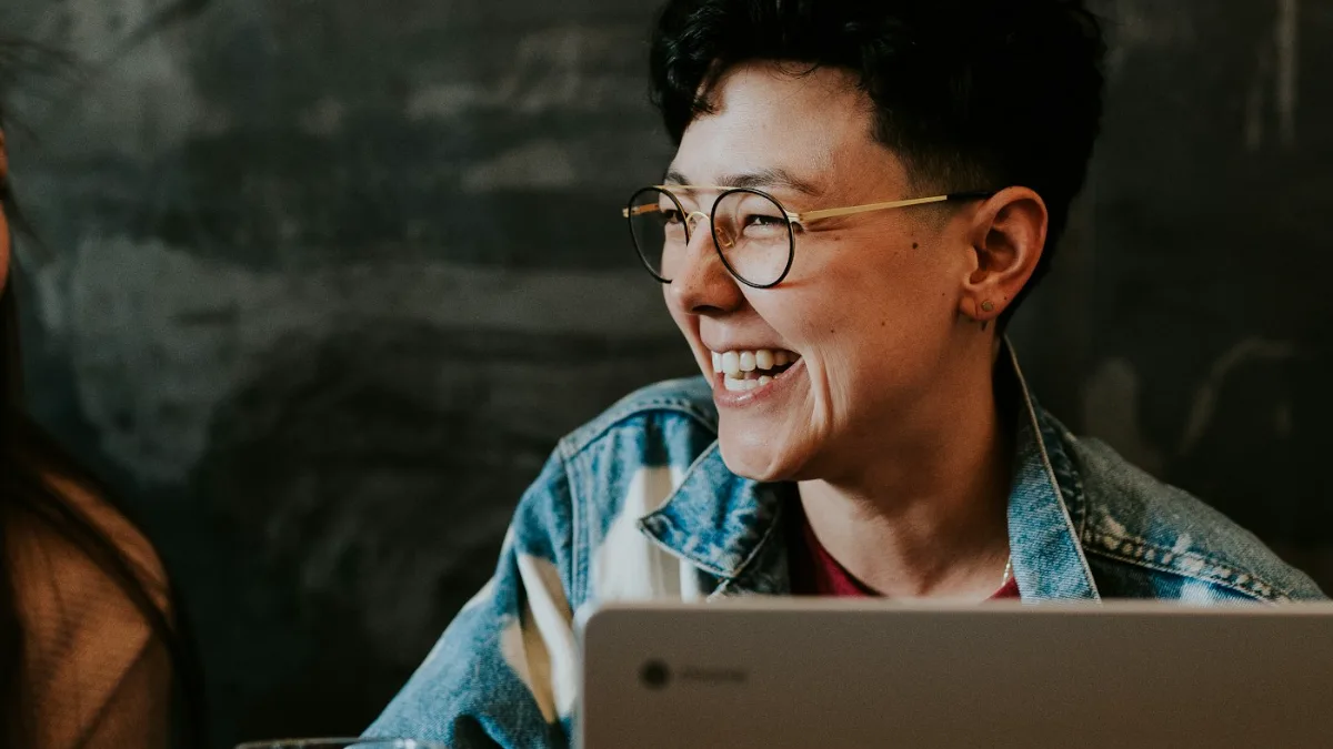 Person laughing at a laptop after their personal information was removed from Yahoo and Bing
