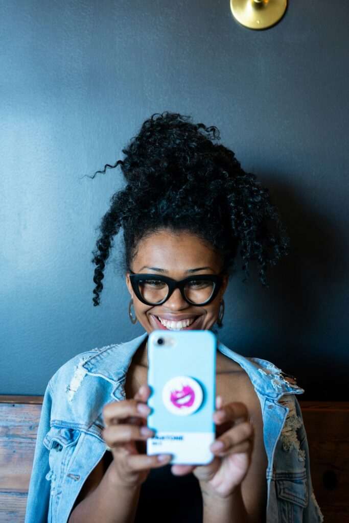 Smiling woman holding a smartphone