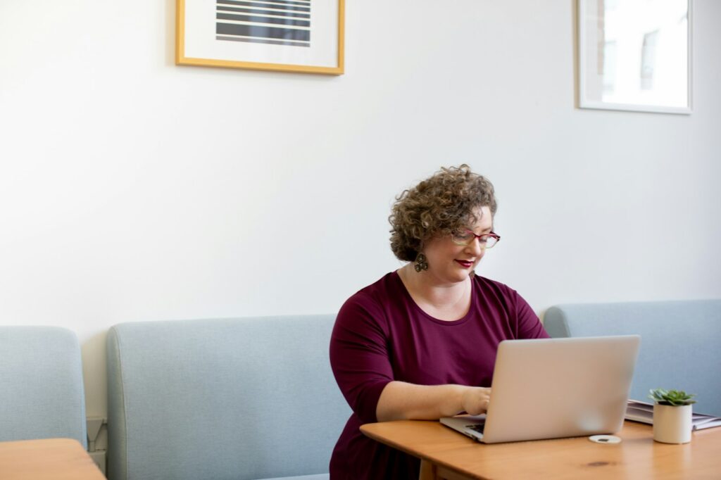 Smiling woman using a laptop at a desk