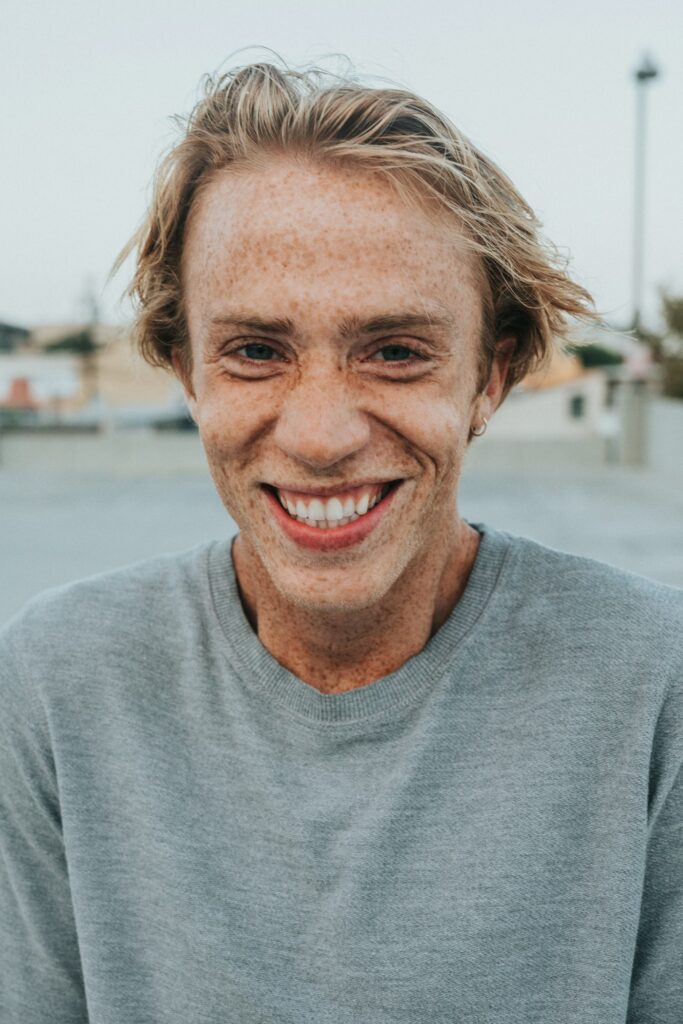 Man in a gray shirt smiling