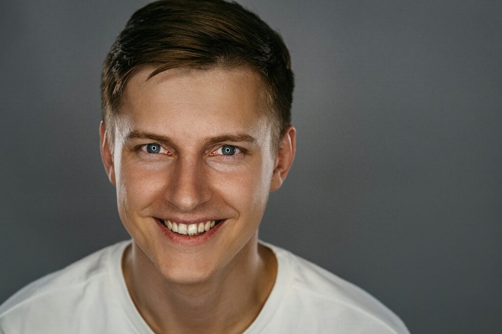 Man in a white shirt smiling