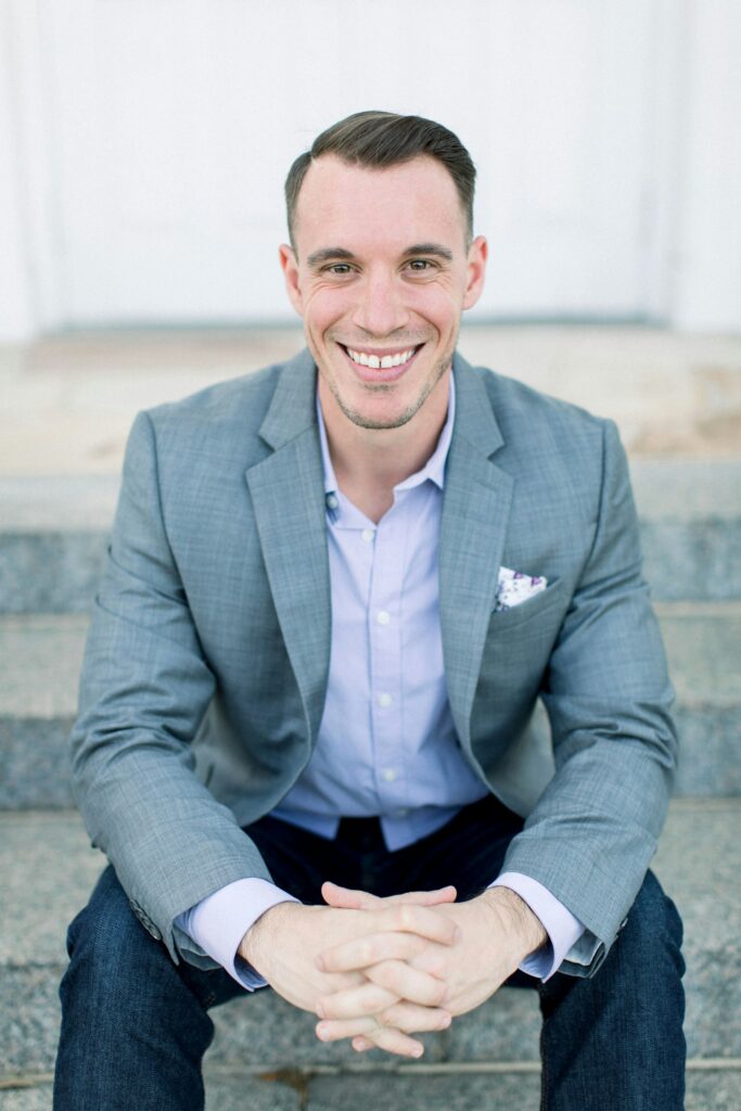 Smiling man in a gray suit jacket