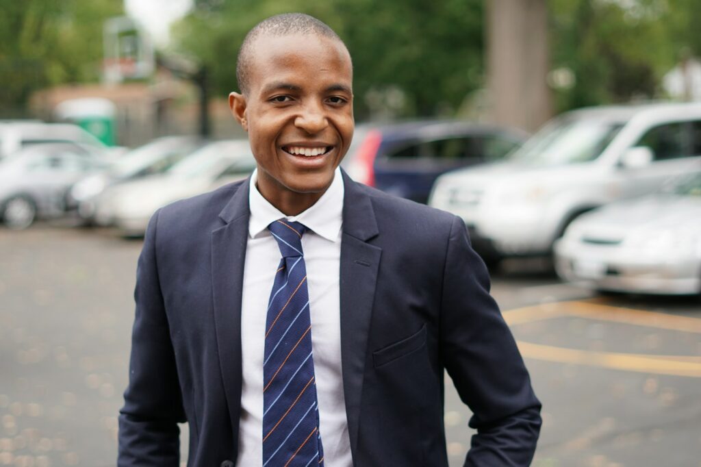 Man in a black suit smiling