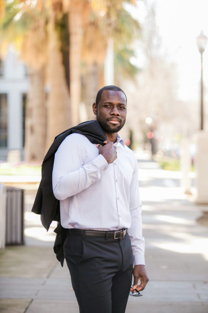 Smiling man in a white dress shirt outdoors