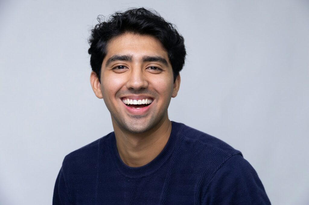 Smiling young man in a dark blue sweater