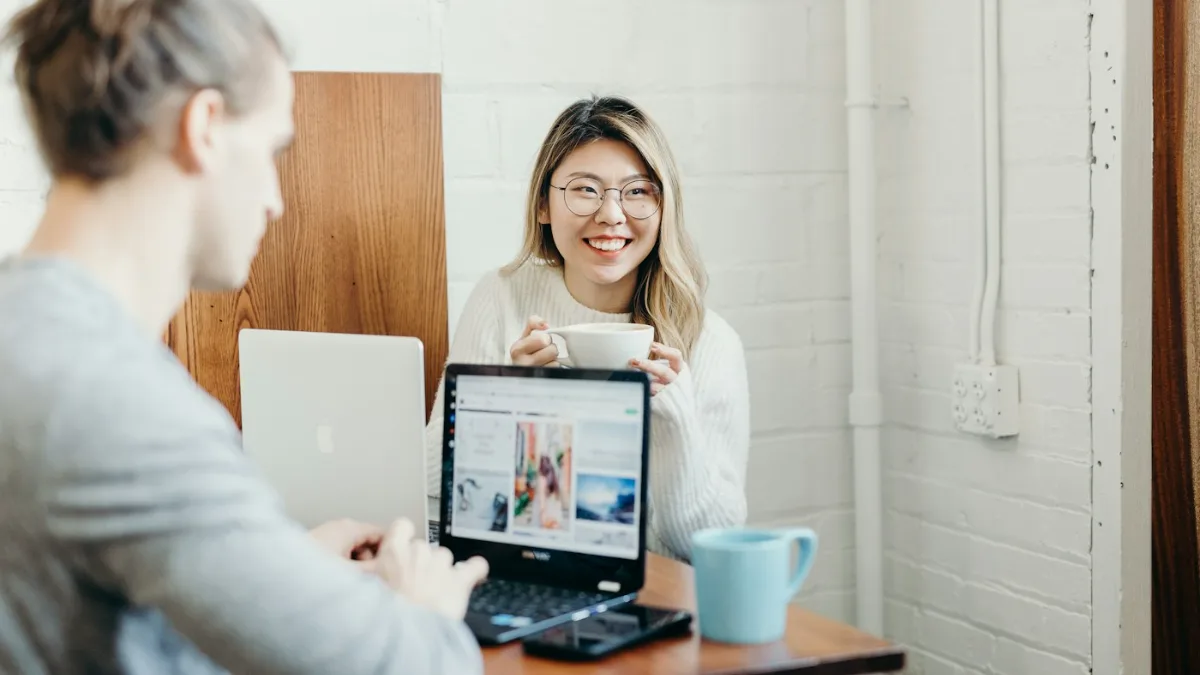 Woman smiling over coffee at her laptop after harmful content about her was permanently removed
